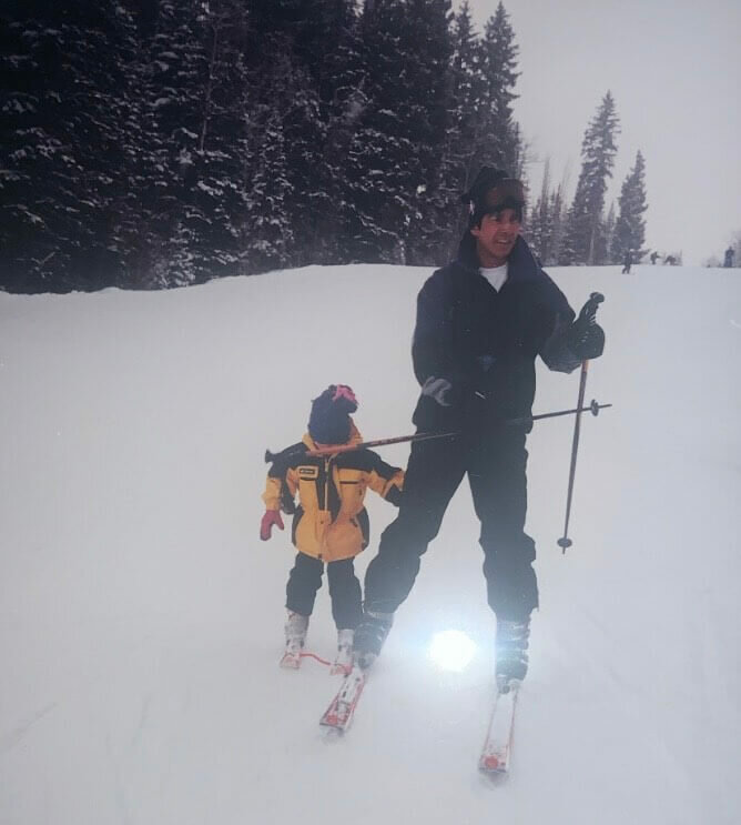 AJ Cutler as a child on the ski slopes getting hit in the face by a pole.